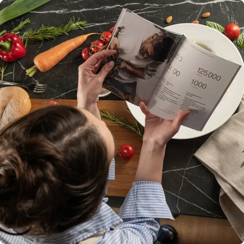 A woman reading Greek Legend catalog
